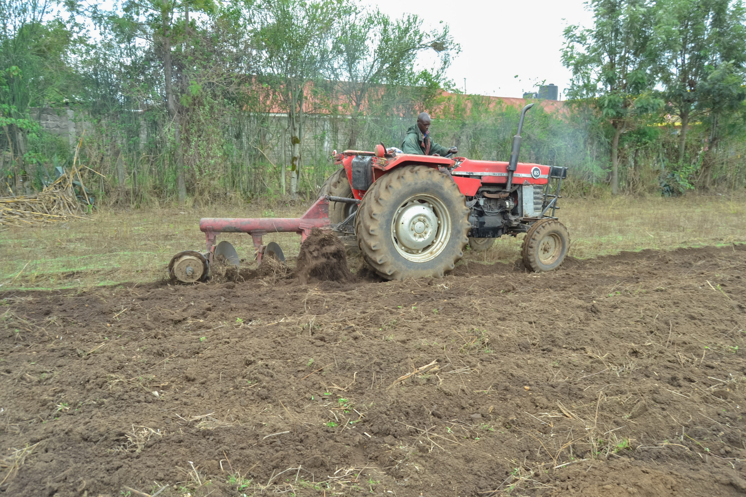 Farmer preparing a field in preparation of planting climate-resilient crops