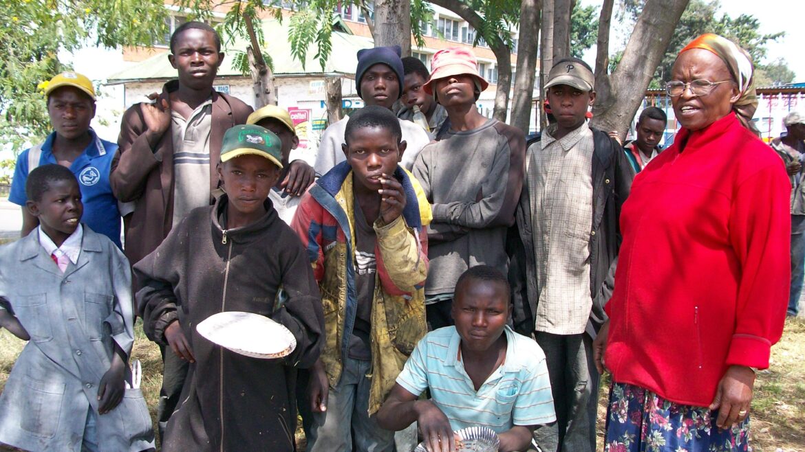 Niva Kegode with street children in Nakuru, Kenya after sharing a meal — the compassion that inspired Mwandani International’s work in value-added agriculture in Kenya.